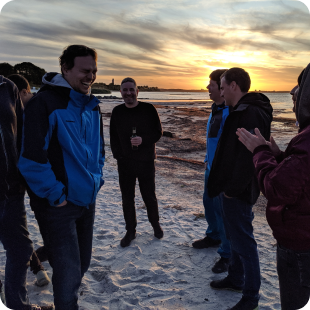 Gitpod team members on the beach