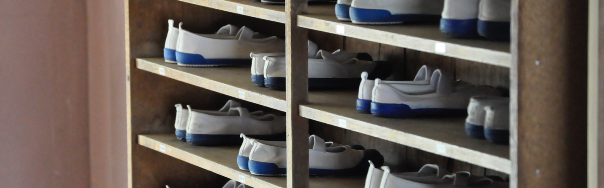 Self-service rack with available pairs of bowling shoes